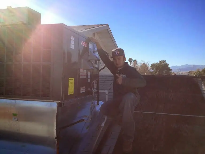 HVAC technician performing HVAC Inspection on a rooftop unit in Silver Lake